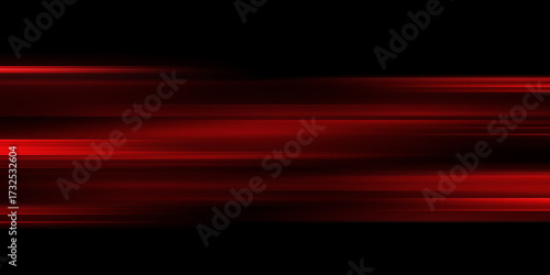 The effect of red light in fast motion on a black background. blurred abstract background with long exposure. neon light
