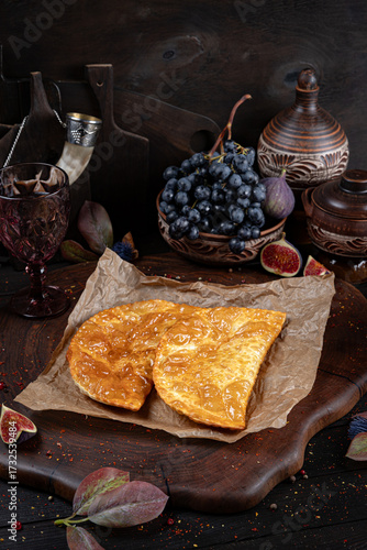 Crispy golden chebureki, traditional deep-fried pastries filled with juicy minced meat. Traditional Georgian Bread. Traditional Georgian cuisine styled with authentic atmosphere.