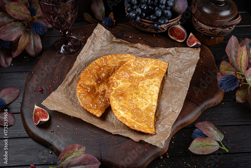 Crispy golden chebureki, traditional deep-fried pastries filled with juicy minced meat. Traditional Georgian Bread. Traditional Georgian cuisine styled with authentic atmosphere.