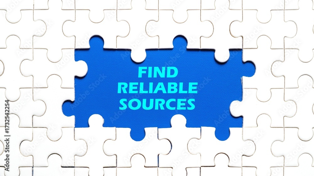 Fototapeta premium FIND RELIABLE SOURCES writing concept in the middle of the puzzle with a blue background.