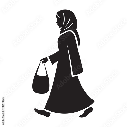 A woman wearing a hijab and abaya walks with a handbag silhouette