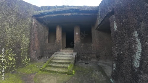 The Historical and Primitive Chamber of a Buddhist Monk within the Kanheri Complex, Featuring Rough-Hewn Walls and Stone Plinths