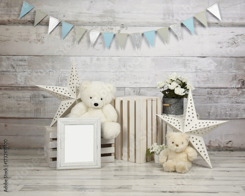 A studio scene of teddy bears with a party banner and a blank frame for a text message for a baby first birthday studio backdrop.