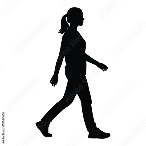 Silhouette of a woman in motion walking with a ponytail posing as a symbol of activity and freedom silhouette