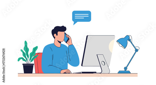 A man is on a phone call while working on his computer at his desk.