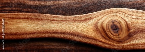 Close-up of a wooden surface, showing grain, texture, and a knot, varying in color and detail