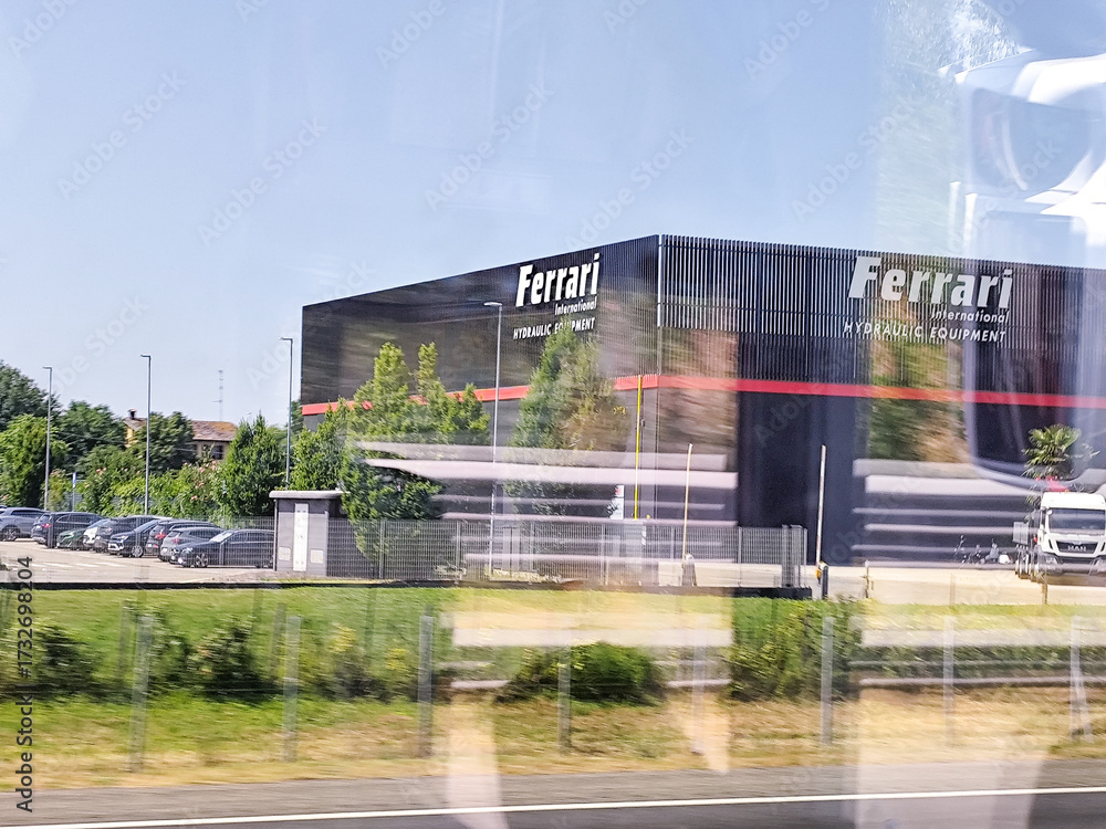 Obraz premium Italy, Reggio Emilia - July 17, 2025: Ferrari International Hydraulic Equipment factory view from car window