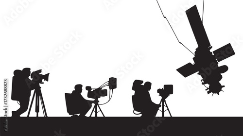 Silhouettes of astronauts filming a satellite in space camera