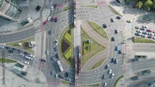 Top-down aerial view of ONZ Roundabout in Warsaw with crossing trams and city traffic, Poland