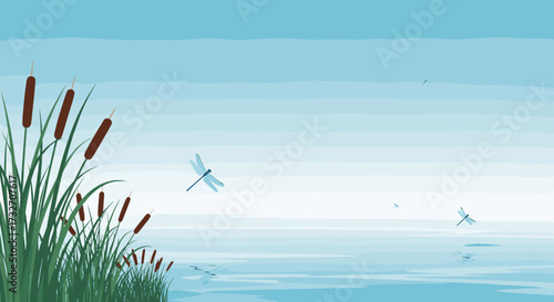 Dragonflies hover gracefully over a tranquil lake surrounded by tall reeds on a serene summer day.