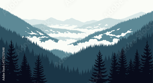 Majestic mountain range shrouded in mist with evergreen forests in the foreground.