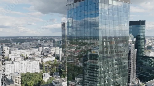 Drone flyby of modern skyscraper in Warsaw