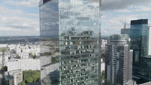 Drone flyby of a modern office building with glass facade in Warsaw city center