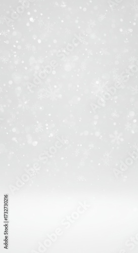 Snowfall in soft focus on white background during winter season  