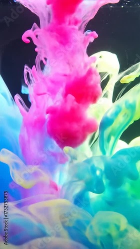 Colorful ink mixing in water creates a vibrant abstract background.