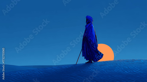 Touareg nomadic traveler with staff in deep blue attire walking across sahara desert under glowing orange sun.