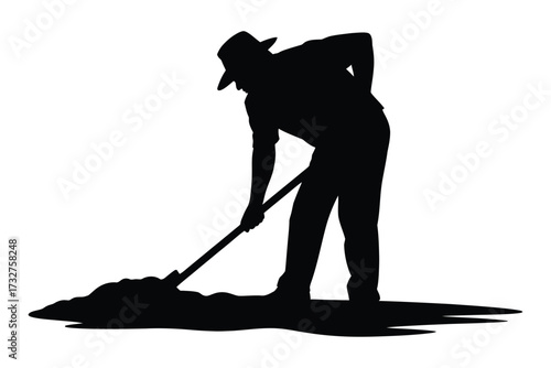 Silhouette of a farmer digging with a shovel in the soil