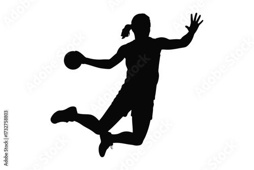 Silhouette of a handball player in mid air during a game