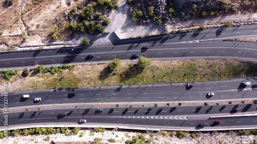 Top down aerial tracking shot of a busy highway. Infrastructure and transportation.
