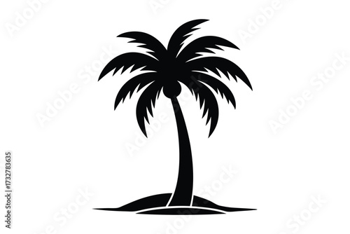 Silhouette of a single palm tree stands on a sandy shore, isolated alone