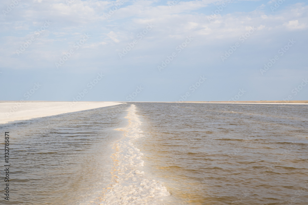 Obraz premium Landscape of a salt lake with a flat white surface under the light of a blue sky. Lake Baskunchak in the Astrakhan region of Russia