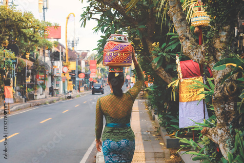 Soft focus on women carrying basket on the head during the celebration in Ubud, Bali, Indonesia