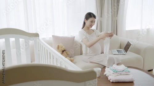 Pregnant woman preparing things for her upcoming baby