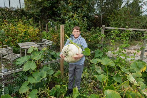 Boy very happy with his huge Crown Pumpkin