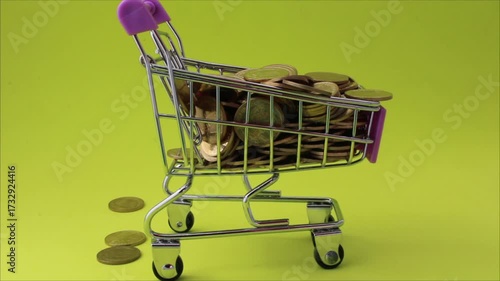Golden coins fall into a shopping cart