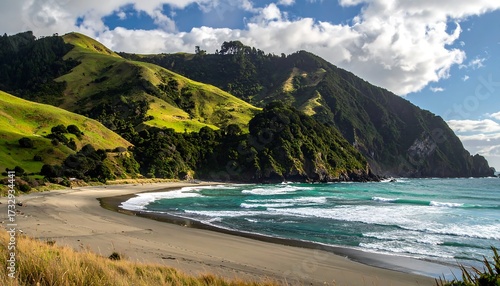 Picturesque coastal landscape with a sandy beach, rolling hills, and turquoise waves