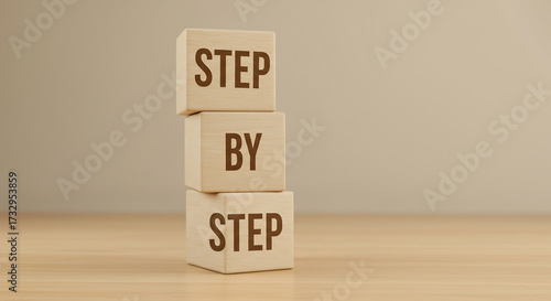 Stacked wooden blocks spell 'STEP BY STEP', symbolizing a clear, structured process and gradual progress