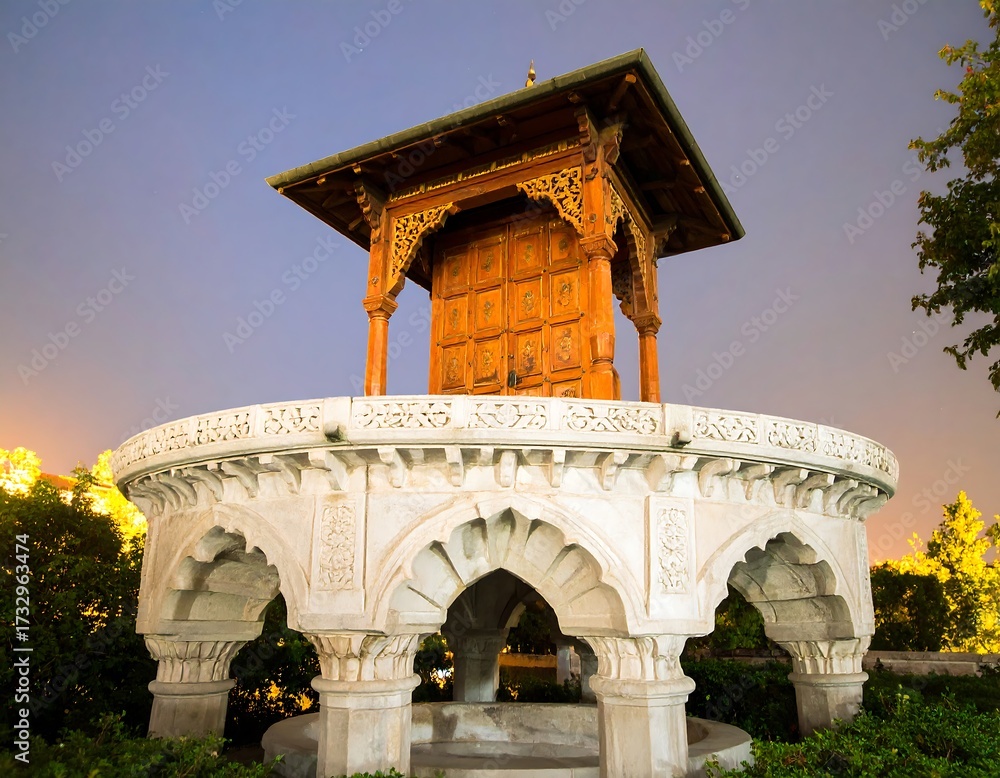 Fototapeta premium Ornate wooden structure on a stone platform at twilight