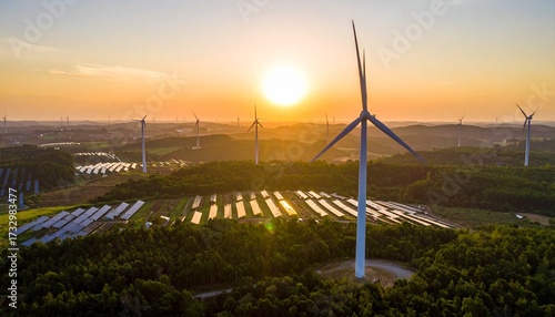 Sunset over a renewable energy farm with wind turbines and solar panels