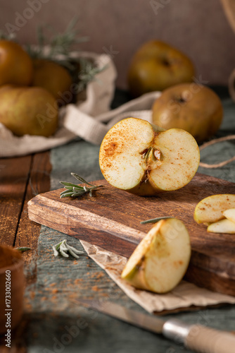 Wallpaper Mural A rustic still life with sliced russet apples sprinkled with cinnamon on a wooden cutting board, evoking a cozy, autumnal mood Torontodigital.ca