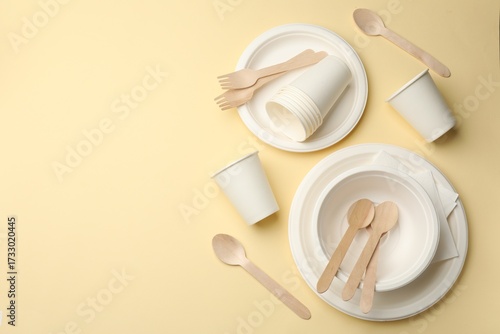 Valokuva Set of disposable tableware on beige background, flat lay