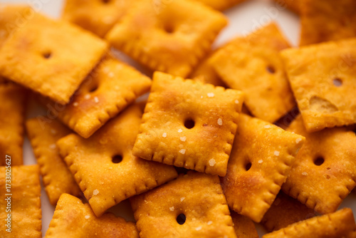Salted Cheddar Cheese square crackers in a big pile 