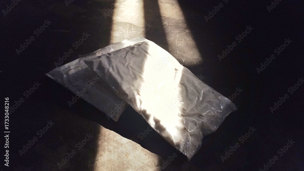 Fototapeta premium two pieces of tempeh, dark background