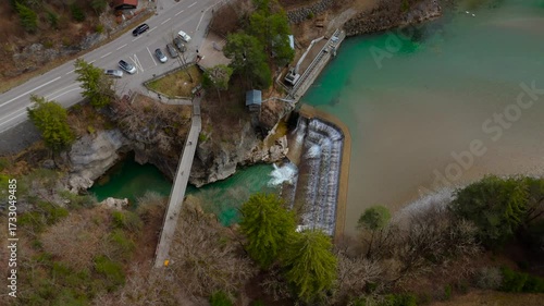 A breathtaking aerial view of Lechfall in Fussen, Germany. The turquoise waters cascade over the dam, surrounded by rugged cliffs and lush forests. A must-visit natural wonder in the Bavarian Alps