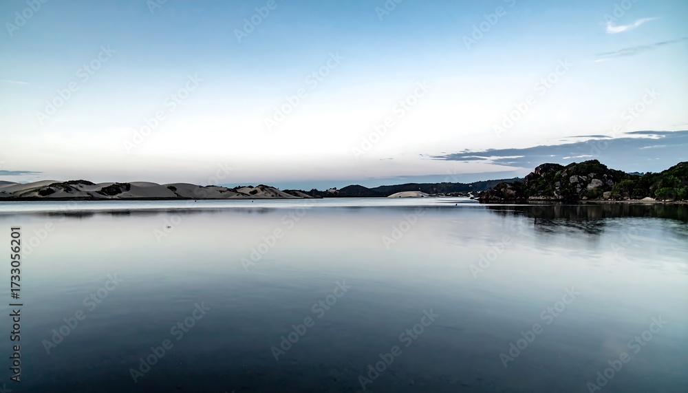Fototapeta premium Calm water reflecting a tranquil coastal scene