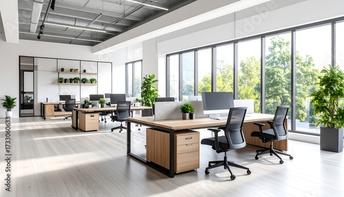 Modern office space with desks with chairs, computers, and and lush green view.