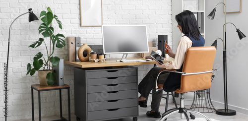Young woman working with co...