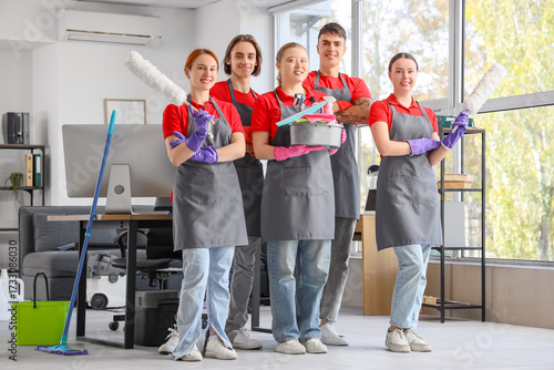 Team of young janitors with...