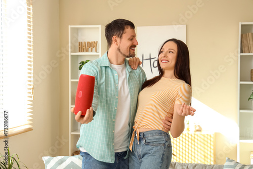 Young couple with portable ...