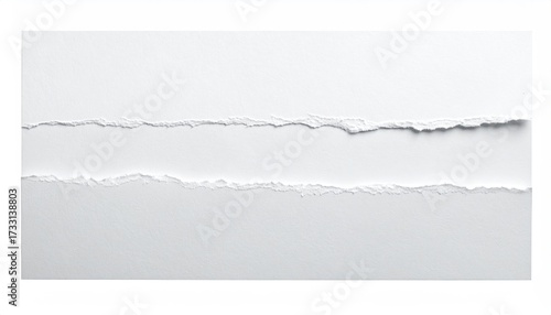 Close-up view of torn white paper revealing a textured, ragged edge