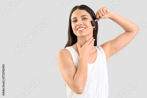 Young woman with tool massa...