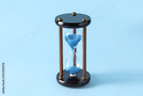 Stylish hourglass on blue b...