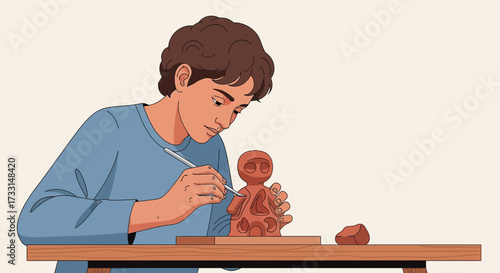 Man creating clay figurine on wooden table.