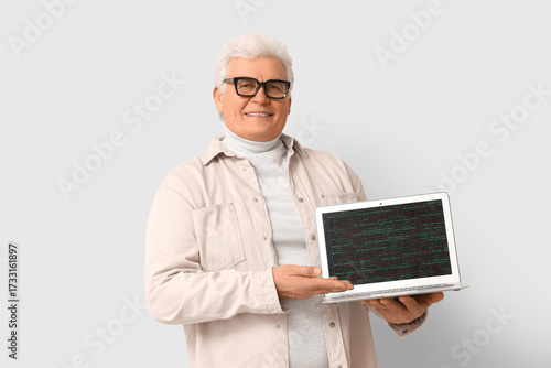 Senior programmer with lapt...