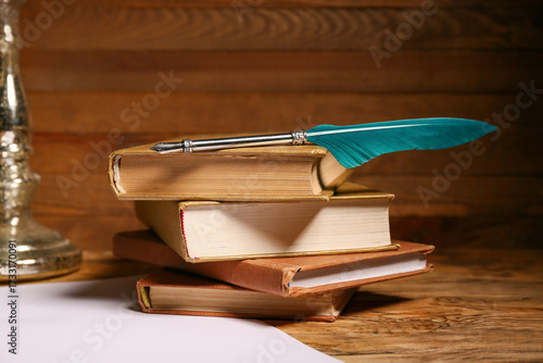 Konstfotografi Books with nib pen and paper sheets on wooden background