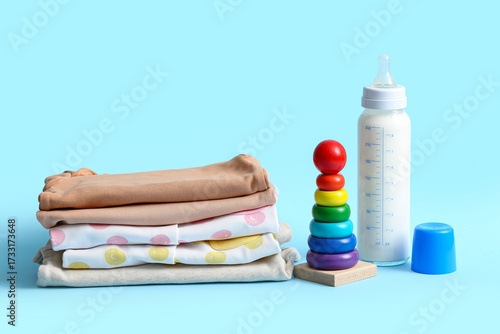 Stack of baby clothes with ...
